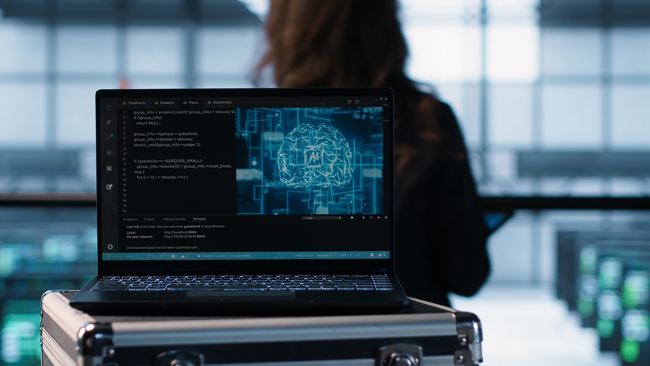 AI coding on notebook screen next to technicians inspecting servers, close up